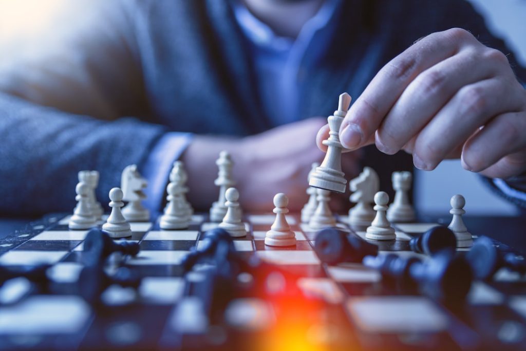 depth-of-field-photography-of-man-playing-chess-fzoitus1diq